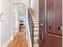 Inviting entryway featuring hardwood floors, an elegant staircase, and an arched doorway at 418 S Habana Ave, Tampa, FL 33609