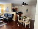 Bright dining area featuring a glass table and seating for four, adjacent to the kitchen at 425 Highland Ct, Dunedin, FL 34698