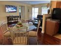 Open living area with a dining table, TV, and comfortable seating for entertaining guests at 425 Highland Ct, Dunedin, FL 34698