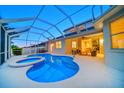Sparkling screened-in pool and spa with a spacious patio area perfect for outdoor relaxation at 434 Arch Ridge Loop # 434, Seffner, FL 33584