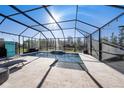 Screened-in pool with ample patio space, perfect for outdoor entertaining with water view at 4607 Ballantrae Boulevard, Land O Lakes, FL 34638