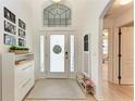 Bright foyer with high ceilings, decorative front door with sidelights, transom window and stylish furnishings at 4712 Trout River Xing, Ellenton, FL 34222