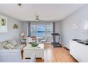 Cozy living room with water view, laminate floors and neutral paint at 4750 Cove Cir # 706, St Petersburg, FL 33708