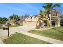 Charming two-story home with a spacious driveway, three car garage, and a well-manicured lawn at 5843 Justicia Loop, Land O Lakes, FL 34639