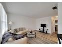 Spacious living room features sleek sofa, stylish floors, and a modern entertainment center at 5850 21St N St # 18, St Petersburg, FL 33714