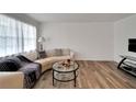 Living room features sleek, curved sofa, hardwood floors, and a decorative coffee table at 5850 21St N St # 18, St Petersburg, FL 33714