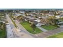Lovely aerial view of a waterfront neighborhood with palm trees, well-manicured lawns, and serene streets at 111 22Nd St, Belleair Beach, FL 33786