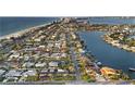 Stunning aerial view showcasing a vibrant waterfront community with boats, beaches, and city skyline at 111 22Nd St, Belleair Beach, FL 33786