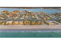 Gorgeous aerial view of a coastal community with pristine beaches and clear turquoise waters at 111 22Nd St, Belleair Beach, FL 33786