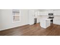 Bright kitchen with stainless steel appliances, white cabinets, and an island at 1515 14Th S St, St Petersburg, FL 33705