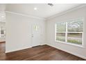 A bright and airy room with a door and large window and wood-style flooring at 1515 14Th S St, St Petersburg, FL 33705