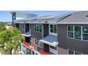 Close up of a modern multi-story condo building with white trim and red railings on the balconies at 17 29Th N St # Lot 7, St Petersburg, FL 33713