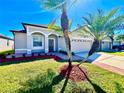 Charming home with well-maintained lawn, two-car garage, and brick-paved walkway at 1945 Fruitridge St, Brandon, FL 33510