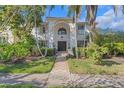 Daytime view of an elegant two-story home with a grand arched entrance and manicured landscaping at 355 21St Ne Ave, St Petersburg, FL 33704