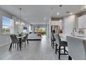 Bright, open-concept living space featuring modern decor, stainless steel appliances, and tile flooring at 3753 Maxwell Park Dr, Sun City Center, FL 33573
