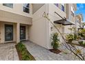 The home features a beautifully landscaped path to the inviting front door with transom window at 4212 Cloud Hopper Way, Lutz, FL 33559