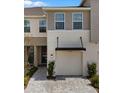 Charming home with a covered porch and a landscaped walkway to the front door at 4212 Cloud Hopper Way, Lutz, FL 33559