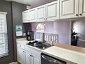 Bright kitchen features white cabinetry, stainless steel appliances, and lots of counter space at 4275 Castlebridge Ln # 1325, Sarasota, FL 34238