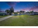 Beautiful one-story home with a lush green lawn under a colorful evening sky at 564 Florida S Cir, Apollo Beach, FL 33572