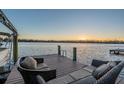 Relaxing lake view from a private dock with comfortable outdoor seating at sunset at 5914 Fitzgerald Rd, Odessa, FL 33556