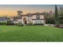 Elegant home featuring a manicured lawn and lovely landscaping that enhances the curb appeal at 5914 Fitzgerald Rd, Odessa, FL 33556