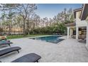 Beautiful backyard oasis with a large pool and comfortable lounge area, perfect for relaxation and entertainment at 5914 Fitzgerald Rd, Odessa, FL 33556