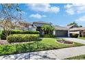 Charming single-story home featuring manicured landscaping, a two-car garage, and a welcoming front entrance at 8942 Aberdeen Creek Cir, Riverview, FL 33569