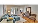 Comfortable living room featuring wood floors, neutral decor, and French doors to the outdoor spaces at 8942 Aberdeen Creek Cir, Riverview, FL 33569