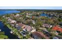 Aerial view of a home surrounded by trees in a waterfront community with access to the bay at 902 Marco Ne Dr, St Petersburg, FL 33702