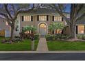 Charming two-story home featuring lush landscaping, mature trees, and a welcoming front entrance at 902 Marco Ne Dr, St Petersburg, FL 33702