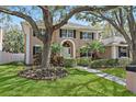 Stately two-story home with manicured lawn, mature trees, and classic architectural details at 902 Marco Ne Dr, St Petersburg, FL 33702