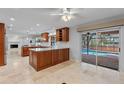 Modern kitchen with custom cabinets, granite countertops, and stainless steel appliances flows to the pool area at 902 Marco Ne Dr, St Petersburg, FL 33702