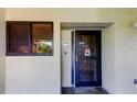 Close-up of the front door with peephole, security screen, and visible unit number at 9433 Harbor Greens Way # 405, Seminole, FL 33776