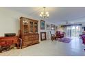 Inviting living room with tile floors, elegant furnishings, and sliding glass doors to the balcony at 9433 Harbor Greens Way # 405, Seminole, FL 33776