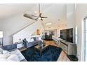 Open-concept living space with vaulted ceilings, modern decor, and seamless flow to the dining area at 9730 Lake Chase Island Way # 9730, Tampa, FL 33626