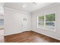 Bright living room showcasing hardwood floors, a door, and a well lit window at 1001 Newton S Ave, St Petersburg, FL 33705