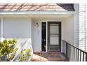 Inviting front entrance with a black door, brick steps, and decorative railing detail at 1331 Abbey Crescent Ln, Clearwater, FL 33759