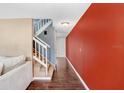 Bright hallway with wood flooring, staircase with white railing and accent wall at 1331 Abbey Crescent Ln, Clearwater, FL 33759