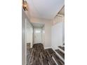 Bright foyer with wood-look flooring, white shiplap accent wall and staircase at 13548 Bellewood Ave, Seminole, FL 33776