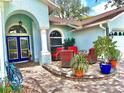 Comfortable outdoor patio area with elegant furniture and vibrant potted plants at 2069 Overbrook Ln, Spring Hill, FL 34606