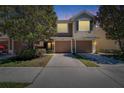 Charming two-story townhome featuring an attached two-car garage and a neatly landscaped front yard at 2128 River Turia Cir # 2128, Riverview, FL 33578