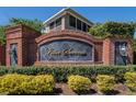 Elegant brick signage with 'Villa Serena' lettering and manicured landscaping at 2128 River Turia Cir # 2128, Riverview, FL 33578