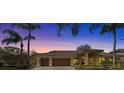 Exterior of a beautiful house at dusk, showing the warm glow of the front lights at 2136 Pinnacle N Cir, Palm Harbor, FL 34684