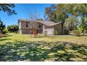 Charming front yard with lush green lawn and mature trees, creating a serene setting at 2903 Oak Crest Dr, Plant City, FL 33565