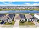 A picturesque view of homes nestled along a tranquil pond, offering a serene waterfront ambiance at 31879 Treasure Dock Isle, Wesley Chapel, FL 33545