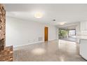 This empty living room features a red brick fireplace, light gray paint, and light colored concrete floors at 360 22Nd Ne Ave, St Petersburg, FL 33704