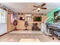 Unique room design with wood paneling, multiple TVs, and functional equipment at 40111 Pretty Redbird Rd, Zephyrhills, FL 33540