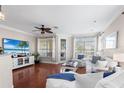 Bright living room featuring hardwood floors, stylish furniture, and a view of the outdoor area at 6327 Sunset Bay Cir, Apollo Beach, FL 33572