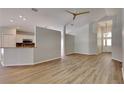 Open-concept living area with wood floors, neutral colors and lots of light at 6805 Winslow St, Sarasota, FL 34243