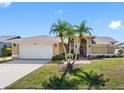 Charming single-story home featuring a well-manicured lawn and a two-car garage at 8640 Chadwick Dr, Tampa, FL 33635